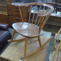 An Ercol elm and beech 452 model cow horn fireside rocking chair