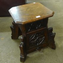 A Victorian Gothic Revival carved oak stool