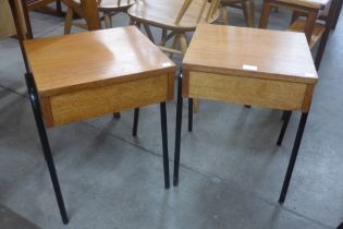 A pair of teak single drawer bedside tables, on black tubular metal stands