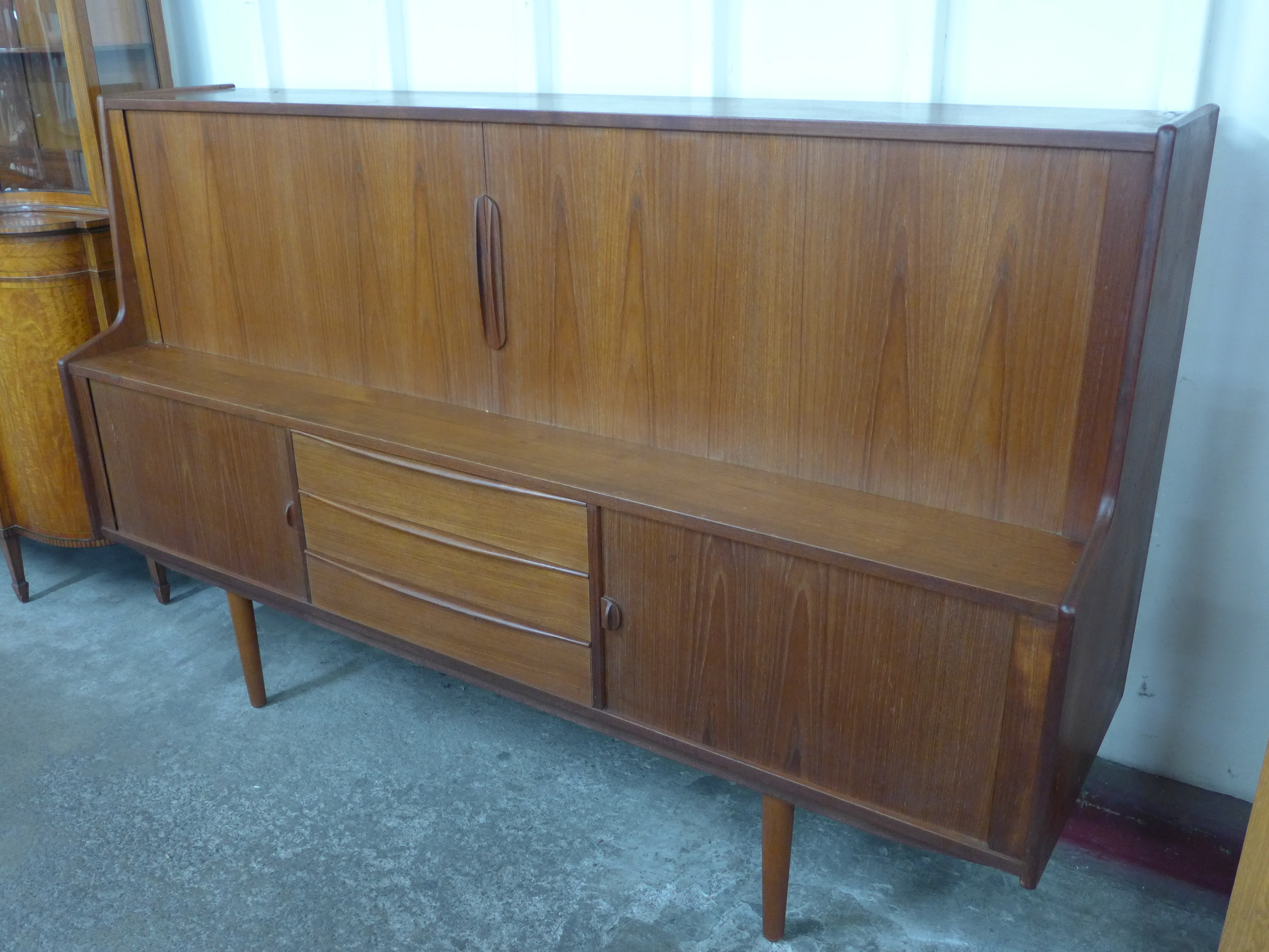 A Danish teak tambour door sideboard