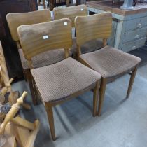 A set of four Beautility walnut dining chairs