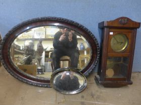 An oak wall clock and two mirrors