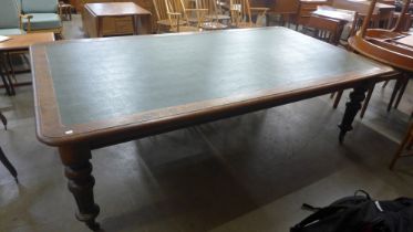 A large early Victorian oak and faux green leather topped library table