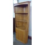 An Ercol Blonde ash freestanding corner cabinet