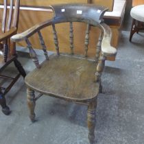 An early 20th Century elm and beech beech smokers bow armchair