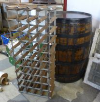 A vintage coopered elm and oak barrel and a pine and metal wine rack