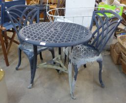 A painted cast alloy garden table and two chairs