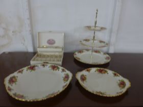 A Royal Albert Old Country Roses cake stand, cake plates and a cased set of spoons