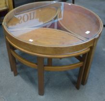 A Nathan Trinity teak and glass topped circular nest of tables