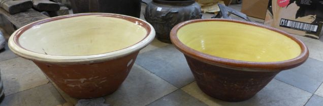 Two yellow glazed terracotta dough bowls