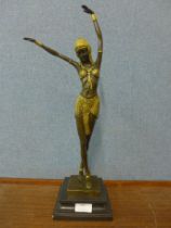 An Art Deco style bronze and parcel gilt figure of an exotic female dancer, on marble socle