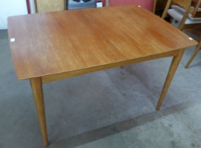 A teak extending dining table