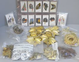 A collection of military cap badges, cigarette cards, etc.