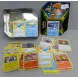 Over 400 Pokemon cards in tin with shiny cards