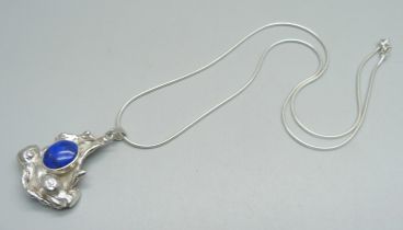 A modern water-cast silver pendant by Andrew Elliot, assayed for maker and set with lapis lazuli,