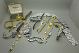A collection of lady's wristwatches, a belt and a scent bottle
