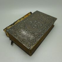 A silver fronted Bible, the cover decorated with Reynold's angels