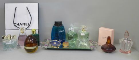 A collection of perfumes, a mirror, etc.