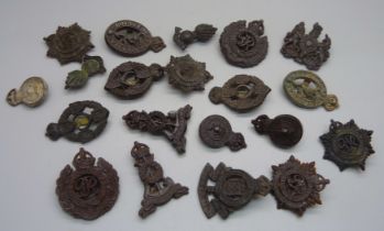 A collection of WWII plastic cap badges