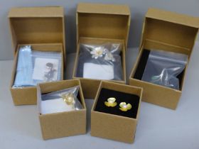 Three pairs of silver earrings, a silver cat necklace and a silver ring, all boxed