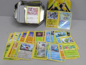 A tin of over 250 Pokemon cards with shiny cards