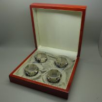 A set of four octagonal silver napkin rings in the Arts and Crafts style set with roundels of Blue