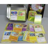 Over 400 Pokemon cards in tin with shiny cards