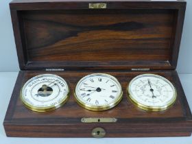A boxed set of clock/barometer and temperature gauge