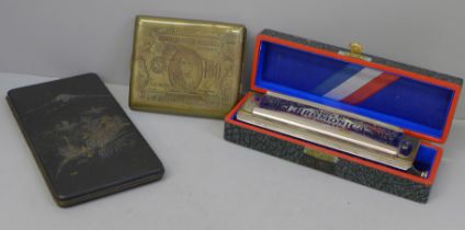 Two cigarette cases and a cased Hohner Super Chromonica harmonica