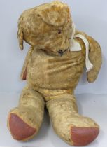 A large plush jointed straw filled vintage Teddy bear, a/f
