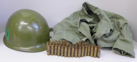 A US M1 helmet, circa 1950 with bullet belt and US shirt