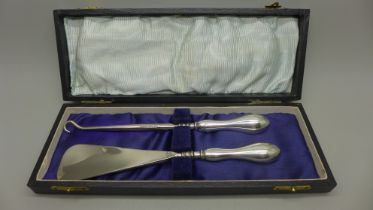 A silver handled shoe horn and a boot pull, cased, Birmingham 1822