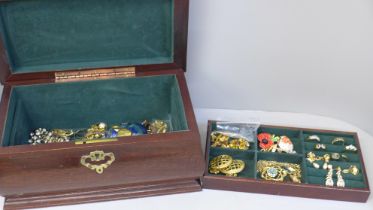 A jewellery box containing gold tone costume jewellery including a pair of Monet earrings, box