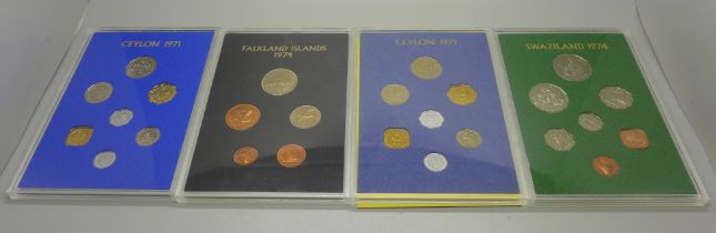 Four Royal Mint commemorative coin sets, Falkland Islands, Swaziland and two Ceylon