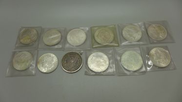 Twelve US dollar coins, pre 1920, one in mount, 335g
