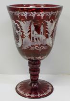 A large red engraved Bohemian spa goblet etched with rural scenes, 21cm