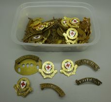 A collection of Red Cross badges and insignia