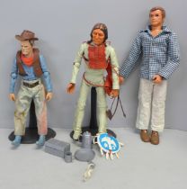 Three vintage action figures including Six Million Dollar Man and Johnny West