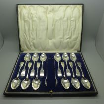 A set of twelve silver spoons and a pair of silver sugar bows, cased, 273g