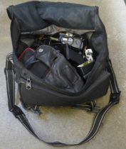 A bag of mixed cameras, compact cameras, SLR cameras, flash units, etc.
