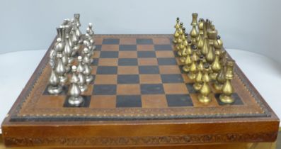 A chess set and board, two metal pieces missing