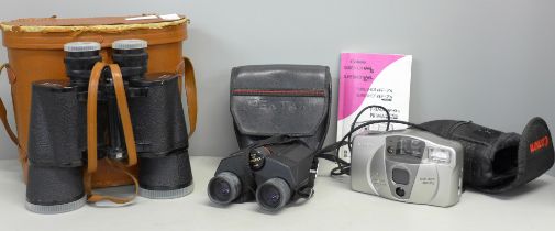 A pair of Pentax binoculars, one other pair and a Canon camera