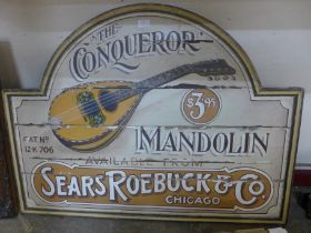 A painted wooden sign; The Conqueror Mandolin