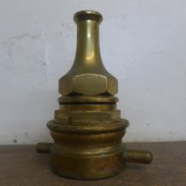 A vintage brass fire hose nozzle