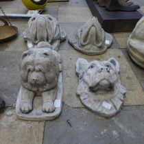 Three concrete dogs and a figure