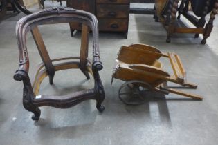 A Victorian style child's carved mahogany chair frame and a vintage Tri-ang toy wheelbarrow
