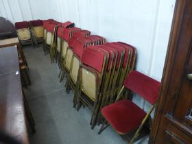 A large quantity of metal framed folding chairs