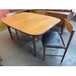 A teak extending dining table and three chairs