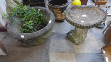 A concrete garden bird bath and a planter