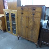 An Art Deco mahogany tallboy and a pine two door bookcase